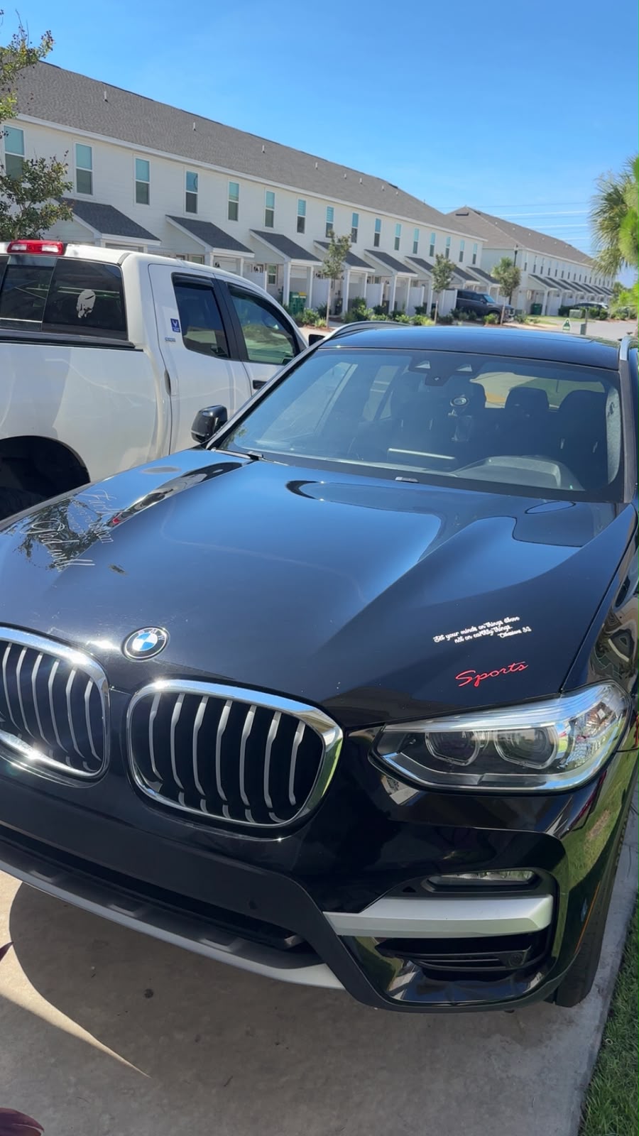 Black BMW SUV in a driveway